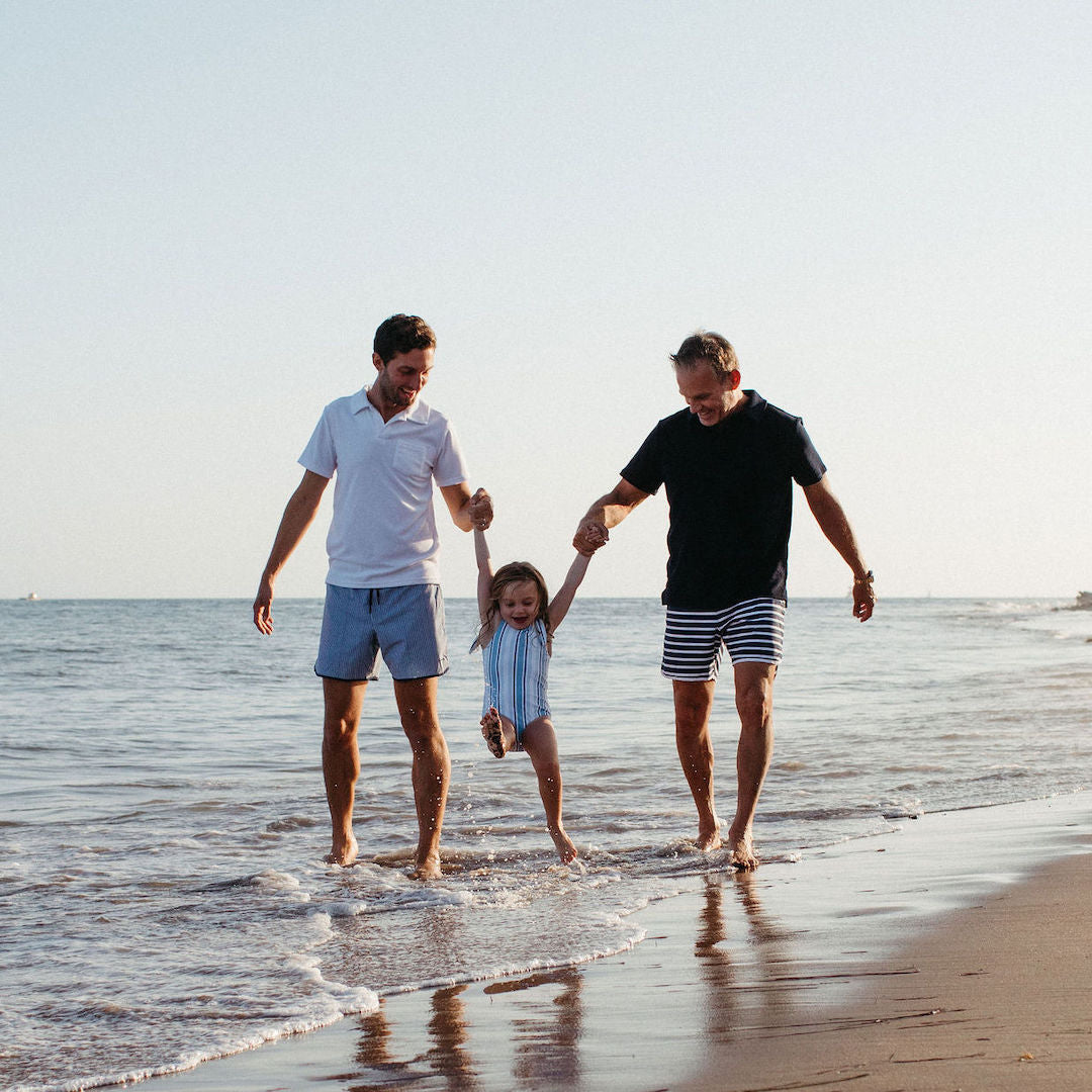 Jeffery Alan Marks, husband, and daughter walking on beach in minnowswim