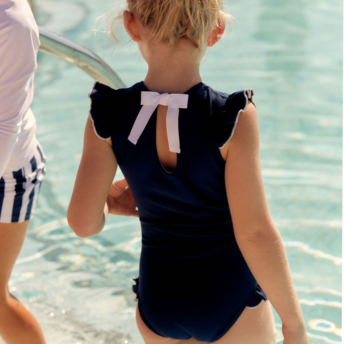 girls navy with white trim ruffle sleeve rashguard one piece