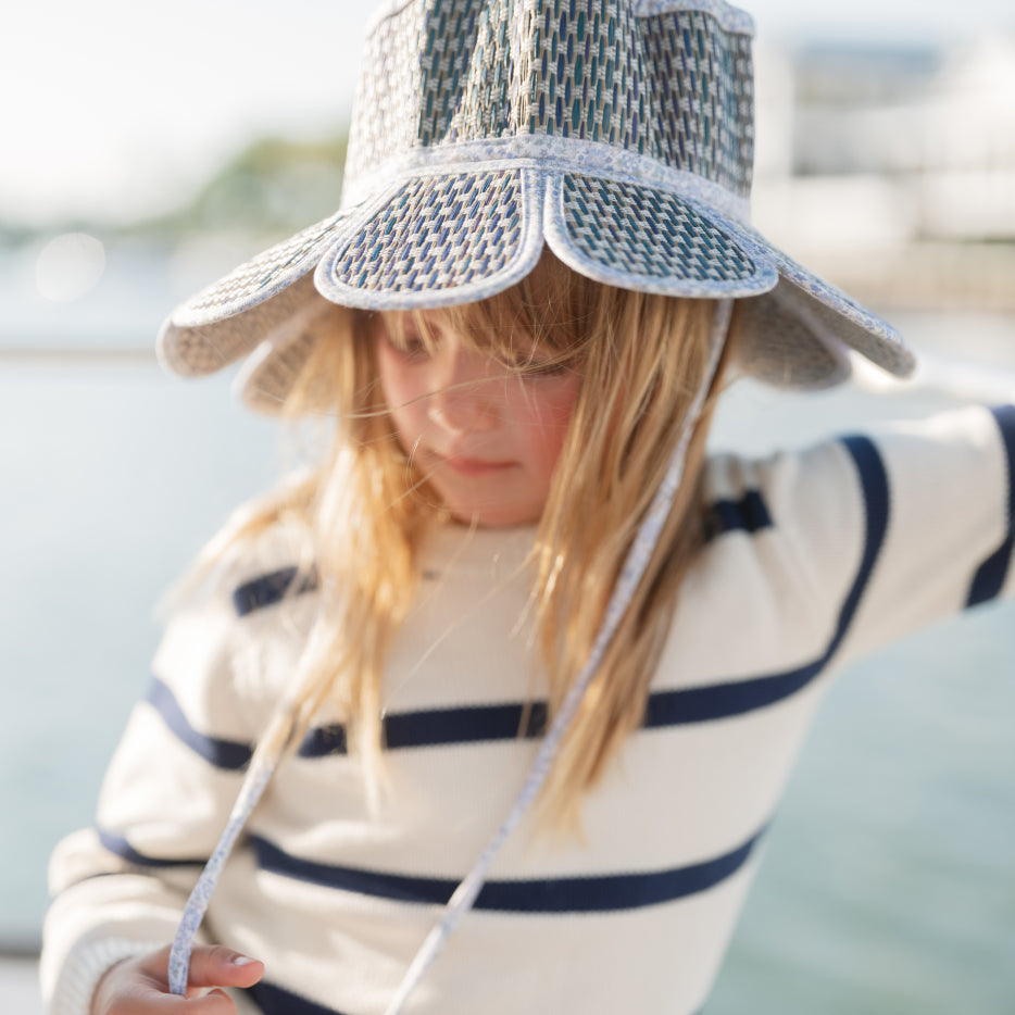 little girl wearing minnow lorna murray hat and knit sweater